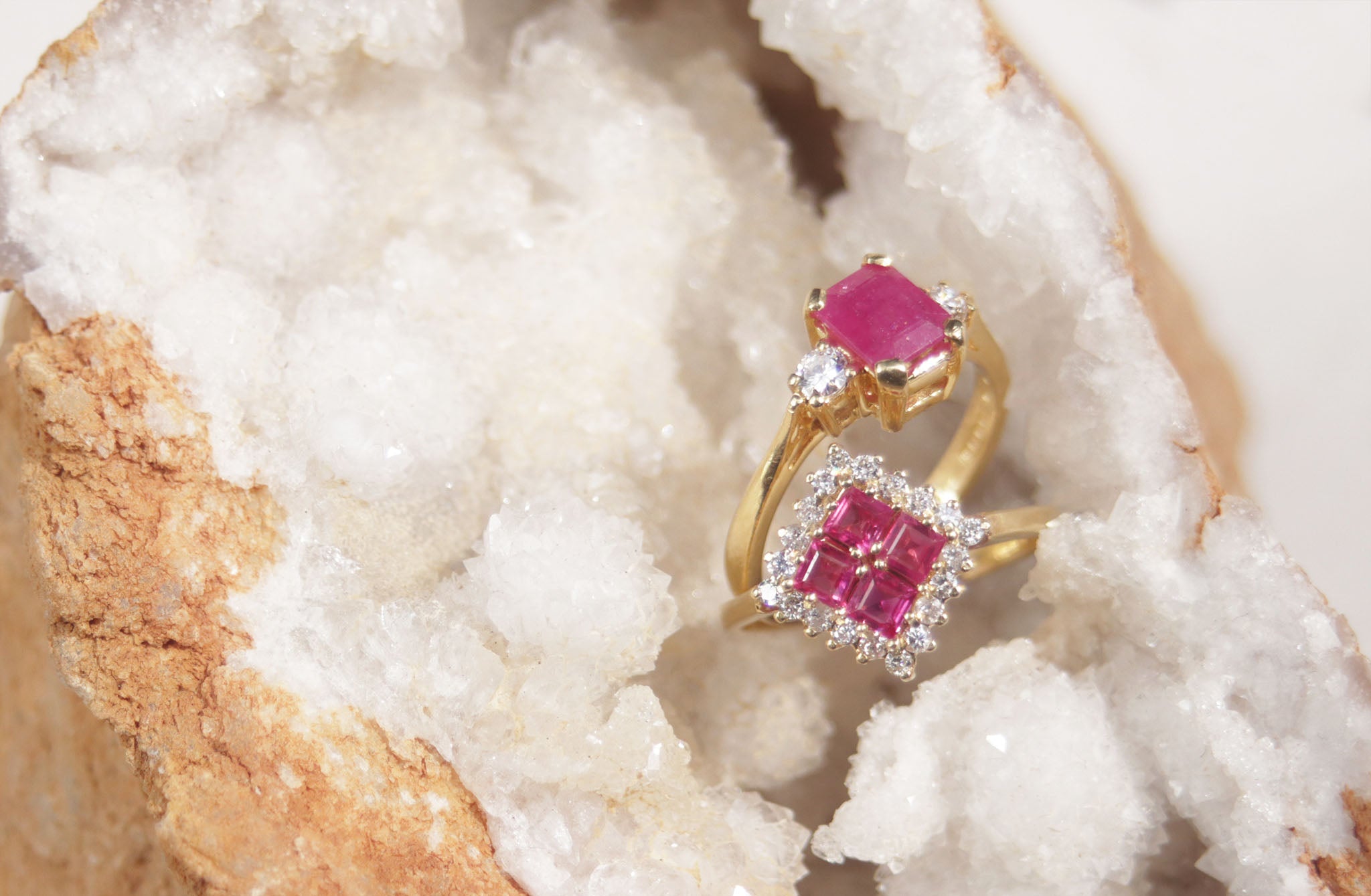 A ladies 18ct yellow gold ruby and diamond vintage ring. This gorgeous piece features four masterfully cut ruby gems. Each gem has a strong red-pink colour with a halo of round brilliant cut diamonds, with a total carat weight of 0.40cts.