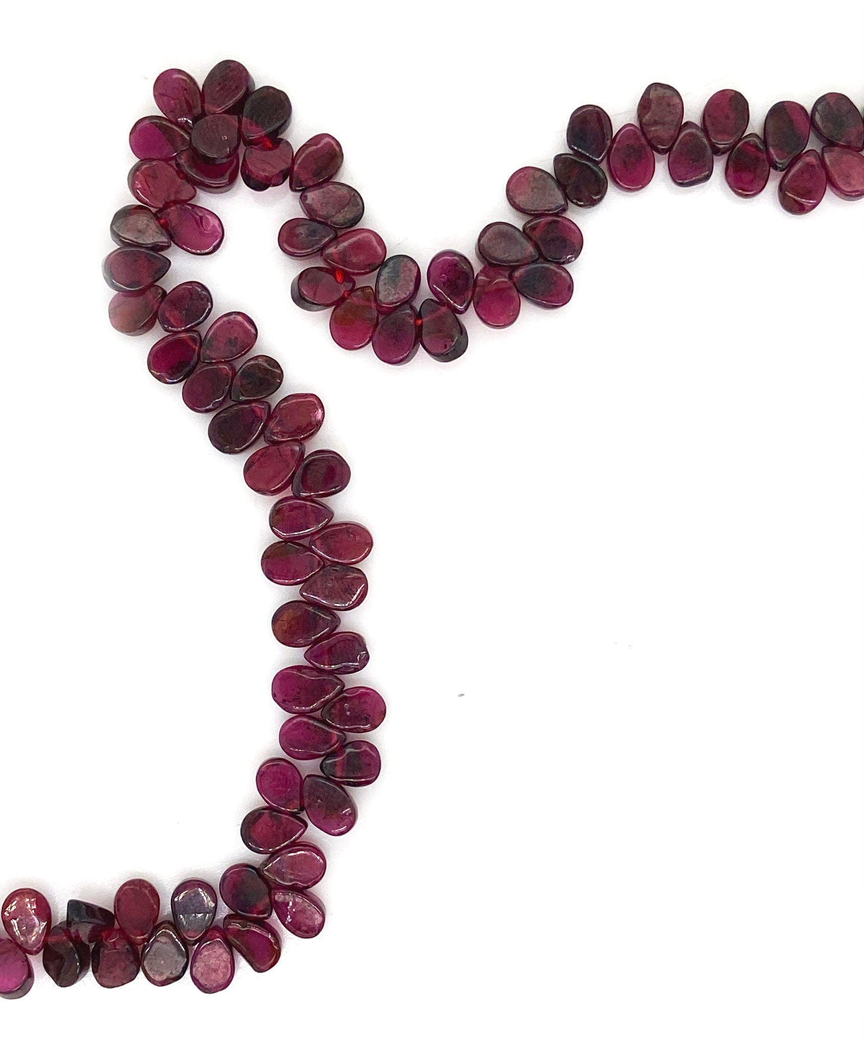 A fancy beaded garnet necklace. This necklace features a string of pear shaped garnet with a sterling silver fastening.  This 16" inch necklace has a 6 cm extension and sterling silver S lock fastening.