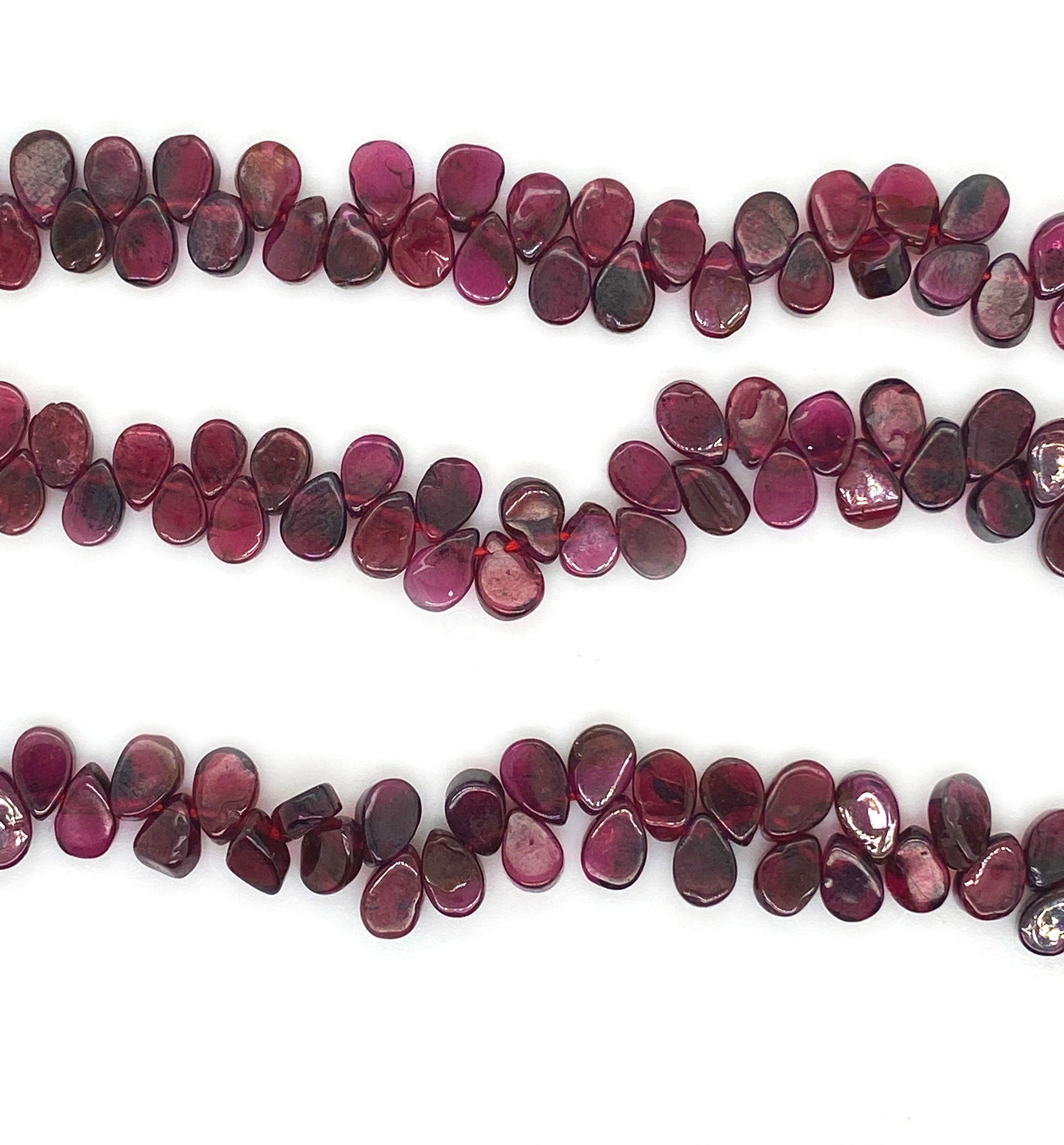 A fancy beaded garnet necklace. This necklace features a string of pear shaped garnet with a sterling silver fastening. This 16" inch necklace has a 6 cm extension and sterling silver S lock fastening.