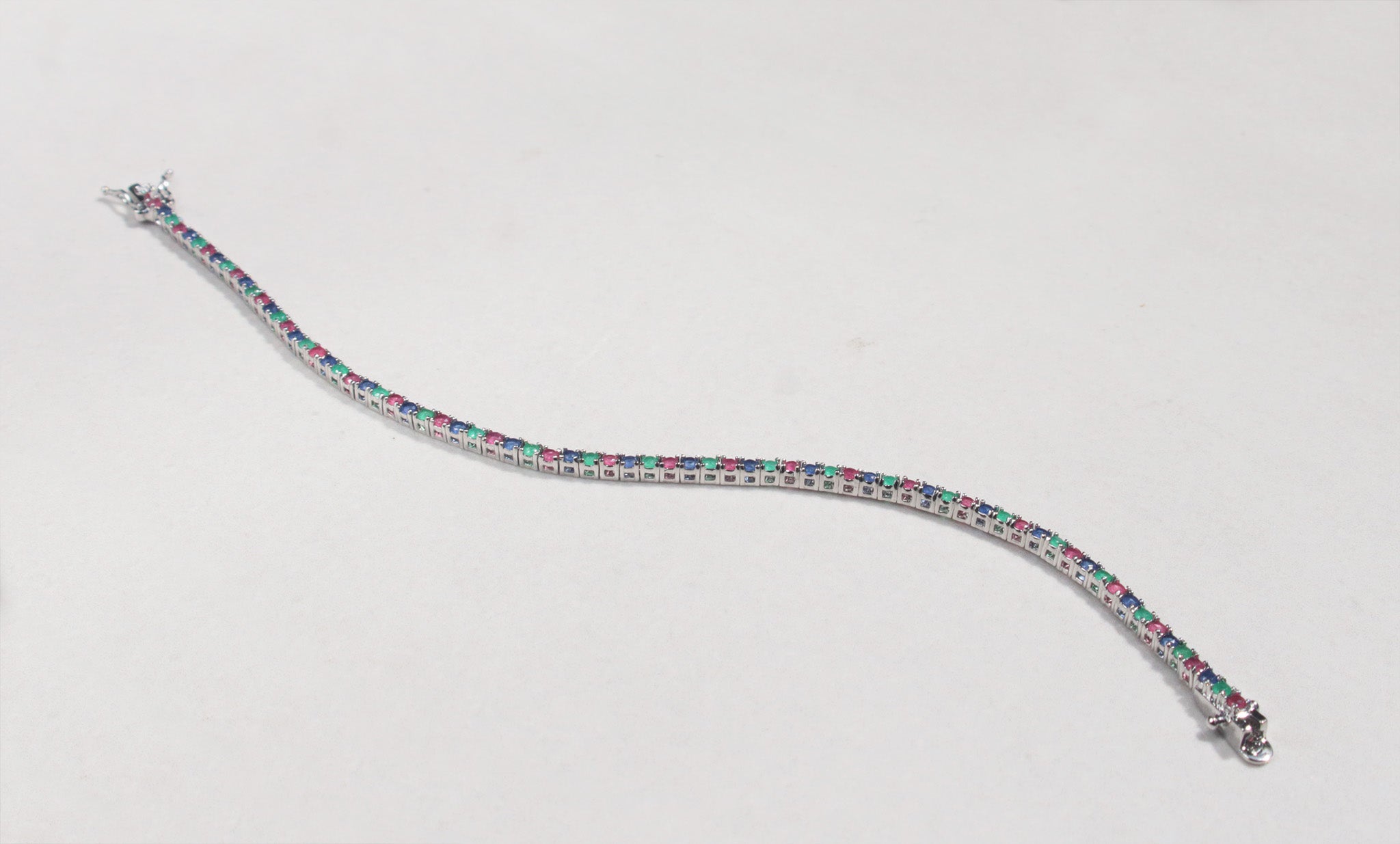 This sterling silver bracelet features a classic arrangement of claw set ruby, emerald and sapphire.This bracelet measures 7.4 inches, with a tongue and groove clasp.