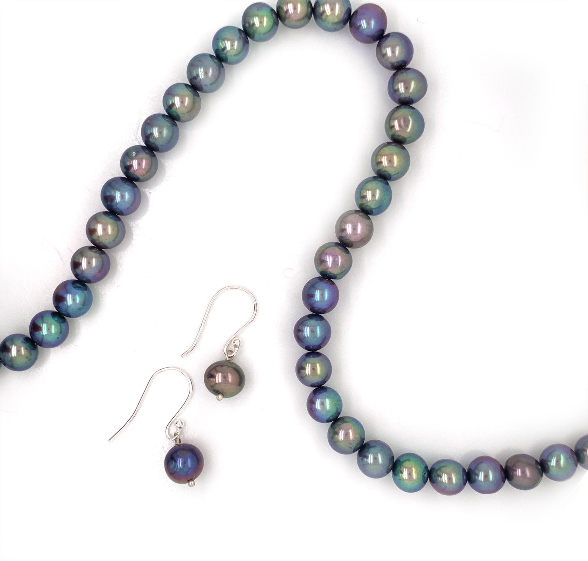 This elegant 20" inch necklace features a string of Tahitian pearls, a natural lustrous material known for its iridescent play of colours ranging from light metallic grey, blue to dark green. This necklace comes with a pair of matching Tahitian pearl ball hook earrings. This necklace includes 51 pearls in total with a circumference of 7 mm with an hallmarked sterling silver S lock