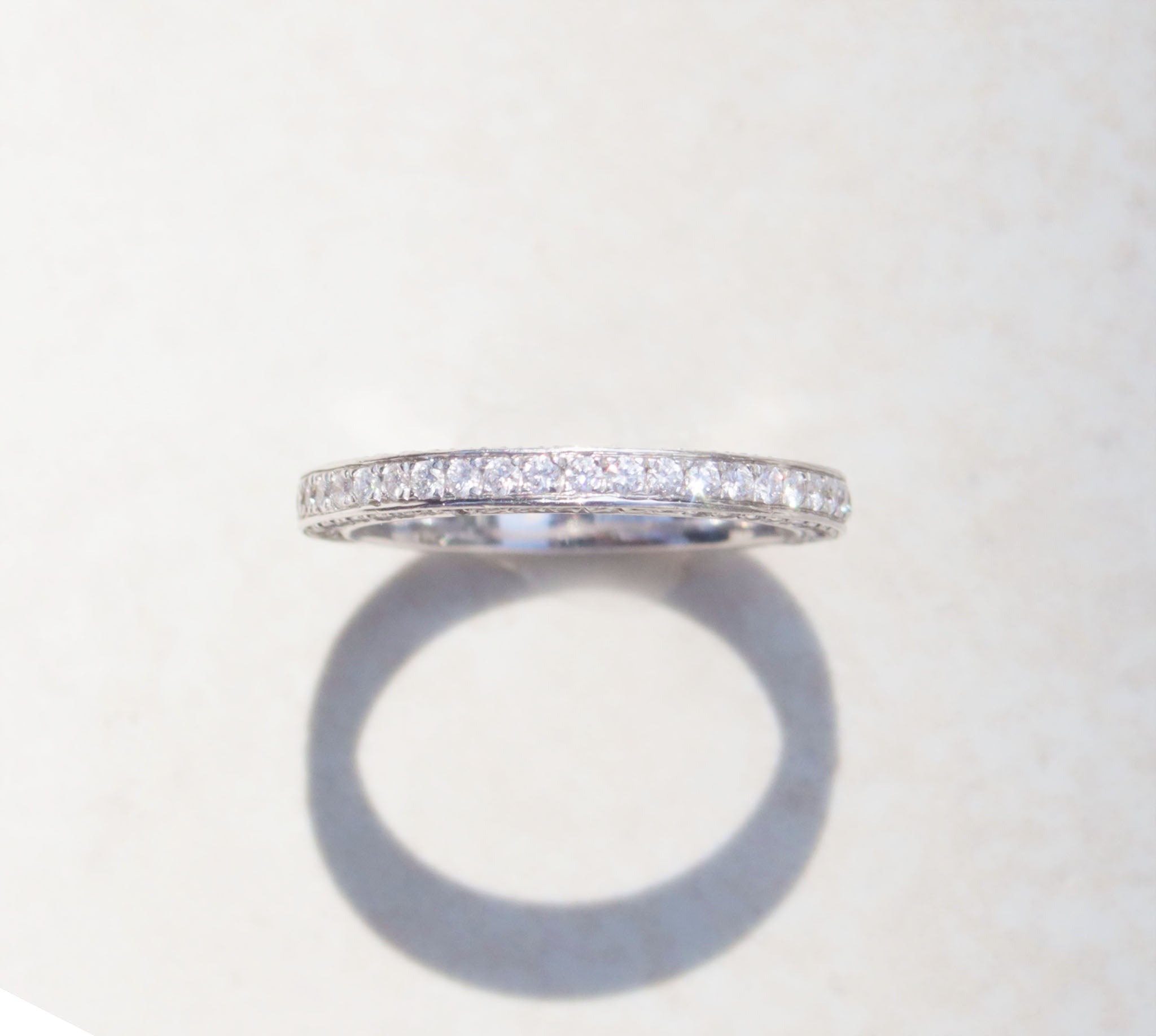 A ladies half eternity ring set in 18kt white gold. This band features round brilliant cut diamonds set on the front and side profiles of the band. Hand made from 18kt white gold Half eternity band Round brilliant cut diamonds, total carat weight 0.90cts SI1, Colour F-G