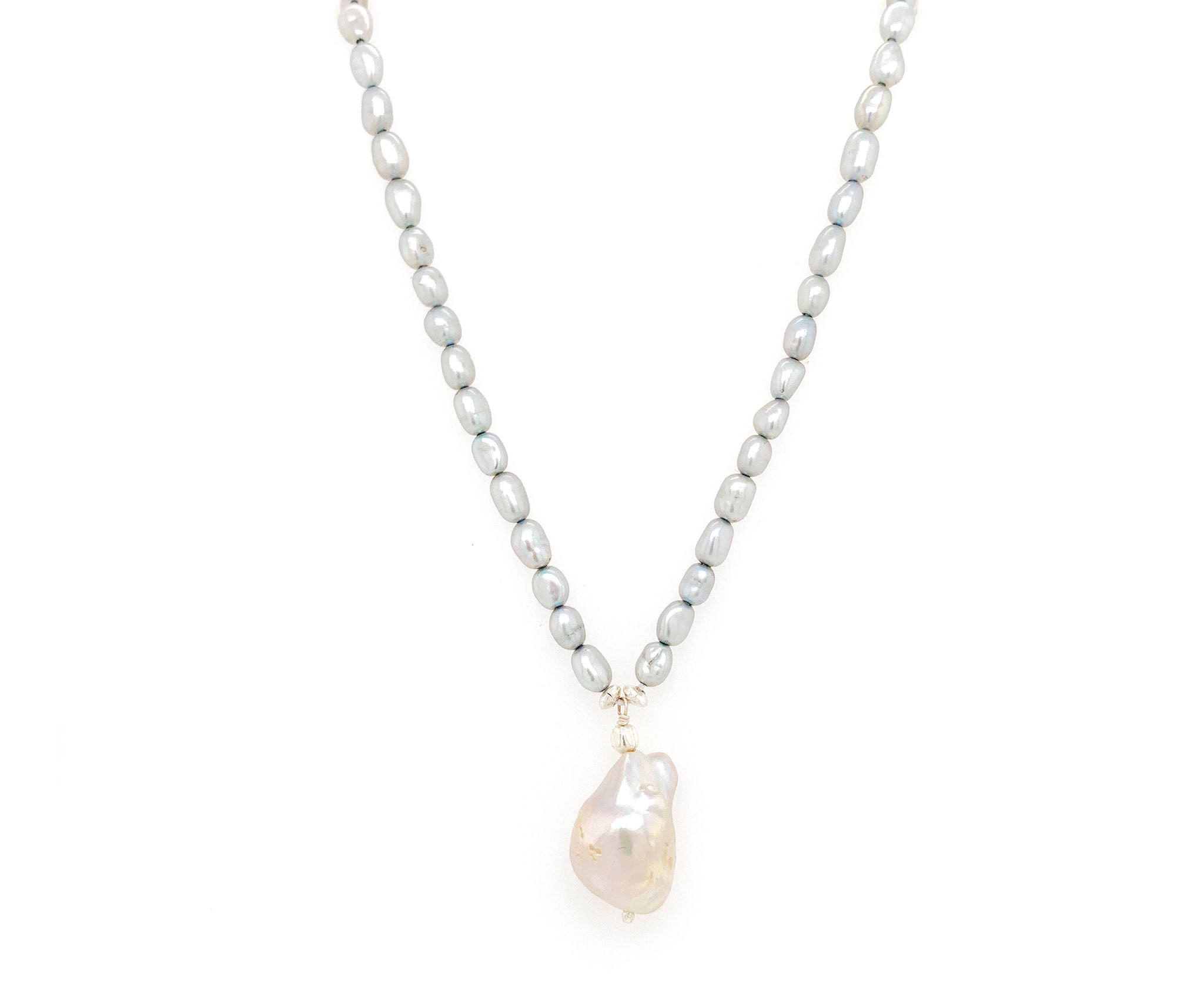 This understated elegant necklace features baroque pearls. A neat string of grey pearls are complimented by an irregular shaped nugget, known as a baroque pearl.  Crafted in 925 Sterling silver, Freshwater pearls and a baroque pearl. This necklace measures approx. 15" inches  Peal nugget (baroque pearl) measures approx. 1.1 mm by 1.8 mm