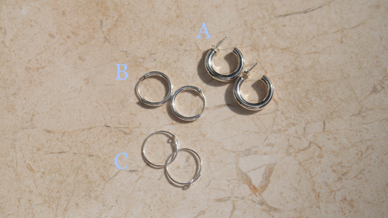 This image shows some of our silver hoops. Hoop A is  a stylish pair of silver hoop earrings .  These polished hinged hoops have a thick tubular body