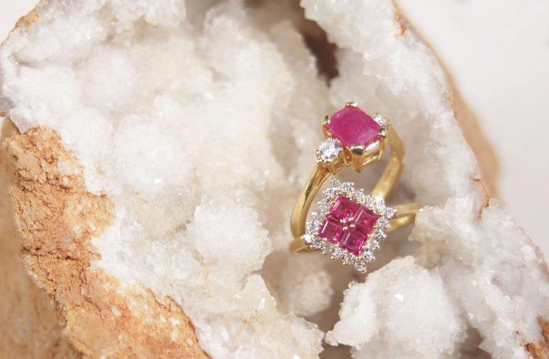 A ladies 18ct yellow gold ruby and diamond vintage ring. This gorgeous piece features four masterfully cut ruby gems. Each gem has a strong red-pink colour with a halo of round brilliant cut diamonds, with a total carat weight of 0.40cts. 