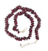 A fancy beaded garnet necklace. This necklace features a string of pear shaped garnet with a sterling silver fastening.  This 16" inch necklace has a 6 cm extension and sterling silver S lock fastening. 