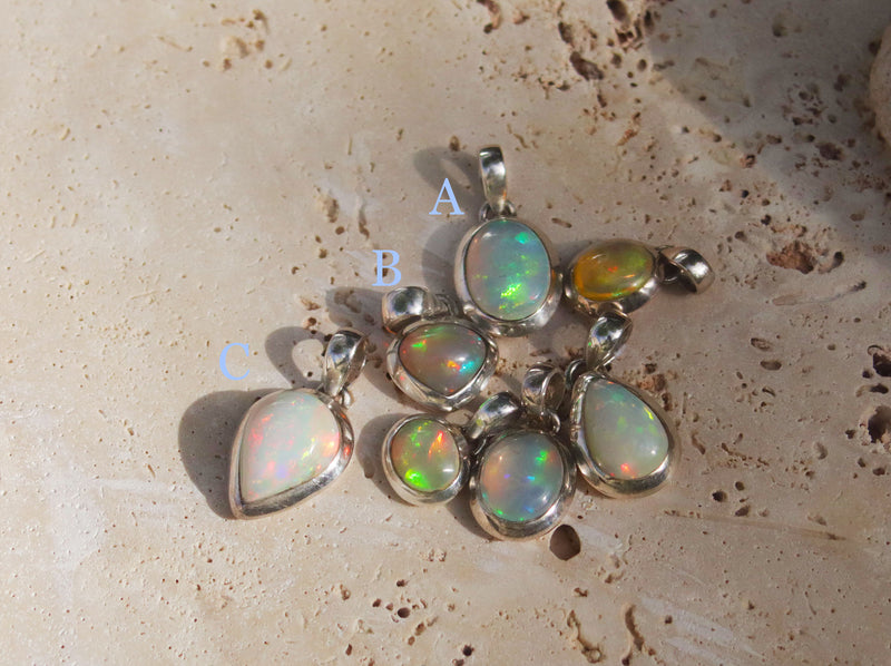 Our Opal pendant collection is available in store. The items listed are available to shop on our website. This image shows a gorgeous Sterling Silver Opal pendant. This oval Sterling silver pendant features an Ethiopian opal, a captivating gemstone known for its kaleidoscopic play of colours.