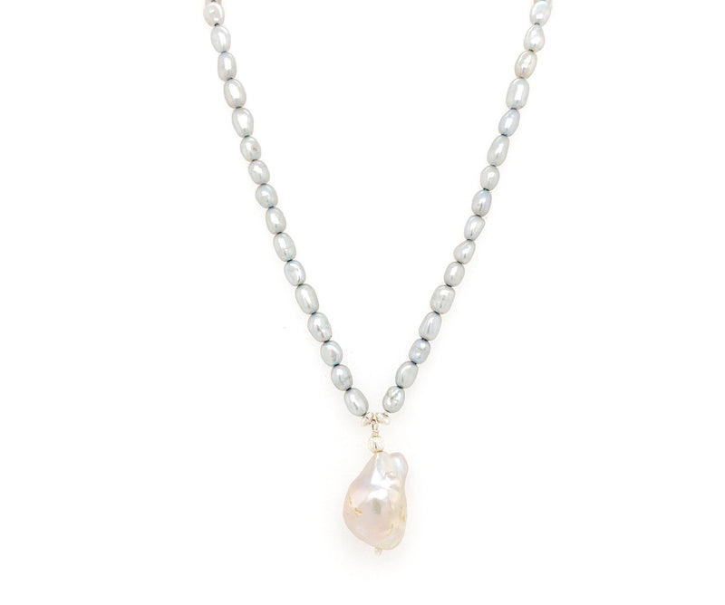 This understated elegant necklace features baroque pearls. A neat string of grey pearls are complimented by an irregular shaped nugget, known as a baroque pearl.  Crafted in 925 Sterling silver, Freshwater pearls and a baroque pearl. This necklace measures approx. 15" inches  Peal nugget (baroque pearl) measures approx. 1.1 mm by 1.8 mm