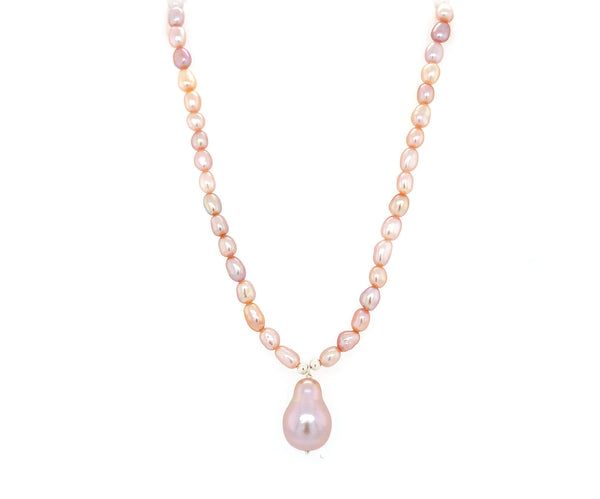 This understated elegant necklace features a pink coloured baroque pearls, a natural iridescent material formed within the soft tissue of shell creatures. A neat string of grey pearls are complimented by an irregular shaped nugget, known as a baroque pearl.    Pearl is the birthstone for June   30th Wedding anniversary   Crafted in 925 Sterling silver, Freshwater pearls and a baroque pearl. This Necklace measures approx. 18" inches  Peal nugget (baroque pearl) measures approx. 1.1 mm by 1.8 mm